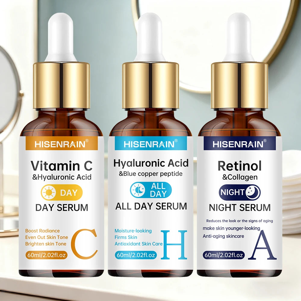 Three skincare serum bottles labeled Vitamin C, Hyaluronic Acid, and Retinol on a blurred background.